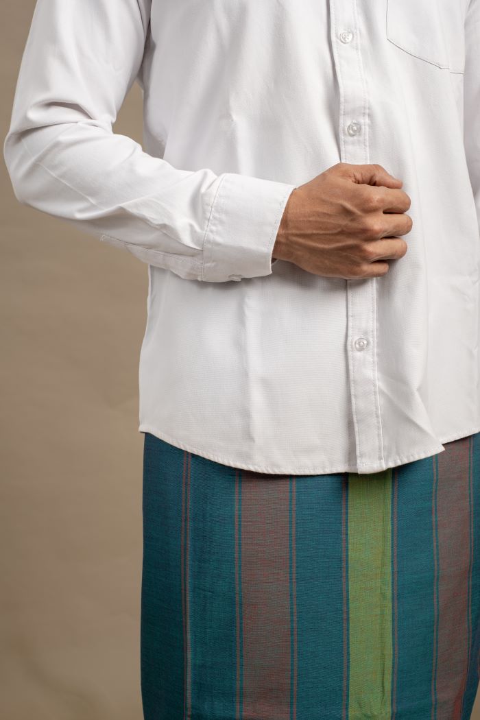 Model wearing a teal handloom veshti by AMBARI